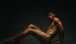 © qunica.com - Artistic depiction of a human male posed against a dark background in dramatic lighting. Highlighting muscular form and artistic photography, conveying mood, expression, and contemplation through