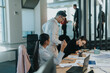 © qunica.com - Business employees engaged in a collaborative meeting in a modern office, discussing projects and strategies. The open workspace is filled with teamwork energy and professional interactions.