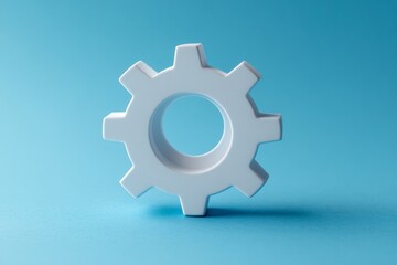 Poster - White gear on blue background demonstrates simplicity in design and functionality for various applications in technology and engineering