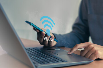 Wall Mural - use business smartphone with wifi icon, business communication social network concept.