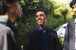 © Wavebreak Media - Teenage diverse boys in graduation gowns smiling and talking in garden, celebrating achievement