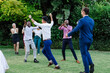 © Wavebreak Media - Celebrating joyfully, guests dancing energetically at outdoor wedding reception
