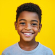 © serz72 - A cheerful Afro American boy, aged 8-10, poses on a colored background, radiating energy and warmth for a playful and vibrant advertising campaign