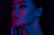 © Mirrorstudio - Young caucasian female in neon lights with hypnotic blue and pink glow