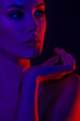 © Mirrorstudio - Moody portrait of young asian female in dramatic red and blue lighting