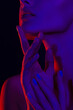 © Mirrorstudio - Female in dramatic neon light with red and blue shadows
