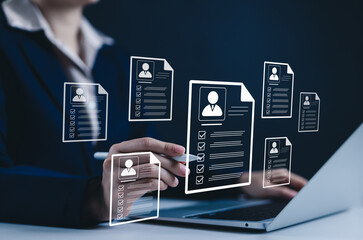 digital resume screening by hr professional. human resource manager evaluate multiple resumes or cv 