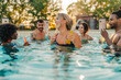 © Zamrznuti tonovi - Friends enjoying drinks in swimming pool during summer party