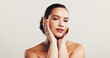 © KayExam/peopleimages.com - Portrait, woman and touch for skincare in studio of natural beauty, facial treatment or dermatology glow. Female person, pride and cosmetics for self care, shine results and space on white background