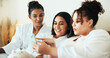 © HockleyM4/peopleimages.com - Phone, friends and relax with women at hotel for spa review, online rating and social media post. Bonding, vacation and resort reputation with people reading on mobile for customer feedback.