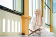 © maya1313 - Ramadan, quran, The image of an Asian Muslim woman in the Islamic religion in hijab in cream color. reading the Quran and having a happy Staying in a beautiful mosque, Arabic word Holy Al Quran.
