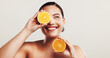 © peopleimages.com - Happy woman, beauty or skincare with orange for citrus detox or vitamin C on a white studio background. Female person, model or smile with natural organic fruit for healthy skin or nutrition on space