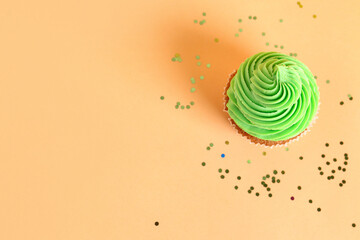 Wall Mural - tasty cupcake on orange background