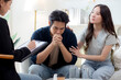 © NT_studio - Young asian couple experiencing marriage counseling, wife comforting partner while talking with psychologist for mental health and consultation, examining health with anxious, medical and couple.