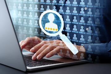 Leinwandbilder - Searching customer management database for target and lead. Analytics and scoring of key client information. Businessman typing on laptop computer keyboard at desk in office.