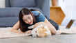 © Bangkok Click Studio - Cheerful asian young beautiful woman happy smile with cute welsh corgi dog while posing with animals comfort lying on carpet floor in living room at home concept lifestyle enjoy love pet best friend.