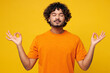 © ViDi Studio - Young spiritual Indian man wear orange t-shirt casual clothes hold spreading hands in yoga om aum gesture relax meditate try to calm down isolated on plain yellow background studio. Lifestyle concept.