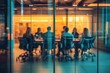 © ttonaorh - Blurred background of a business meeting in a modern office with people sitting at a table, a team working together having a discussion. View through a glass wall
