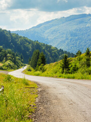 Wall Mural - old country road winding through mountainous countryside. curvy pass direction to valleyy. wonderful