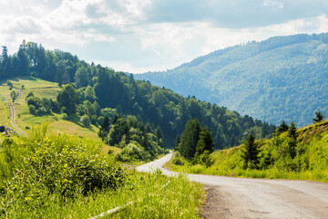 Wall Mural - old country road winding through mountainous countryside. rural scenery. wonderful summer landscape.