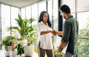 Wall Mural - two happy diverse multiethnic business team people working, talking in corporate office