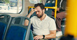 © peopleimages.com - Travel, passenger and man with headache, public transport and exhausted with long journey in morning. Commuting, traveller and business person with migraine in bus, burnout and stress for trip