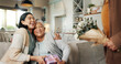 © CC/peopleimages.com - Birthday, gift or laughing with family on sofa in living room of home together for bonding or celebration. Box, funny or hugging with senior woman and daughter in apartment for event or milestone