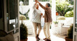 © CC/peopleimages.com - Mature couple, dancing and spin in home with love, bonding and celebration for anniversary. People, man and woman with holding hands, retirement and smile for twirl, rhythm and relationship at house