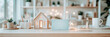 © sommersby - Concept Home Decor: Cozy arrangement featuring a model house, plants and mug for sale promotions, home staging mockups or real estate showcase.