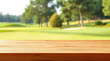 © Rhony - Empty wooden table with blurred golf course background.