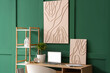 © Pixel-Shot - Interior of stylish room with workplace, laptop and picture on green wall