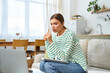 © LIGHTFIELD STUDIOS - Engaging young woman immersed in online learning at home during a sunny afternoon
