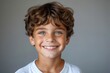 © Сергей Белый - Close-up Portrait of a Handsome Young Boy Model Flashing a Bright, Sparkling Smile in a Professional Studio Setting