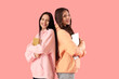 © Pixel-Shot - Happy teenage girls with books and laptop on pink background