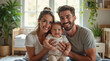 © Olga Ко - Familia joven y feliz con un adorable bebé sonriendo juntos en casa, posando para la cámara. Tasa de natalidad, demografía - Parents' Day. Happy family. Baby and the parents photo