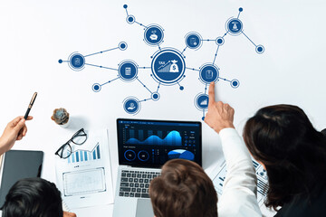 Aufkleber - A group of professionals collaborates in a modern office, examining tax data with charts and a laptop, emphasizing teamwork in financial planning and strategic analysis. Amity