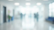 © Shootdiem - Blurred image of a bright hospital hallway featuring medical beds, carts, and equipment. Clean, sterile environment with natural light.