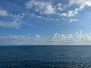 Wall Mural - calm blue sea and cloudy sky horizon
