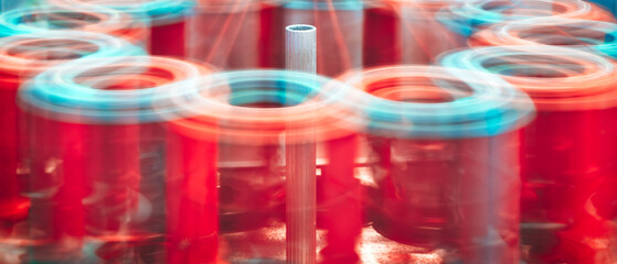 Poster - Machine spinning red yarn, machine spinning and motion blur