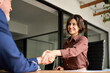 © insta_photos - Smiling female hr hiring recruit at job interview, insurance agent, lawyer making contract deal at work with business handshake. Happy young business woman bank manager handshaking client at meeting.