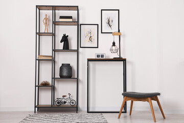 Aufkleber - Shelving unit with different home decor and chair near white wall indoors