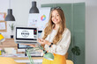 © Pixel-Shot - Female web designer with laptop in office