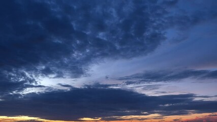 Wall Mural - 4K: A timelapse where vibrant sunset clouds shift dramatically, revealing the captivating light play between day and night. Stock footage. Time-lapse. 
