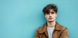 © J. Grayscale - Stylish Young Man Posing Against a Vibrant Blue Wall in Casual Fashion