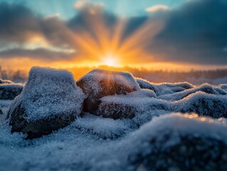Wall Mural - snowy rocks at sunrise with sun rays.