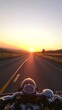 © gan - Motorcycle adventure at sunrise, feeling the open road on an epic journey