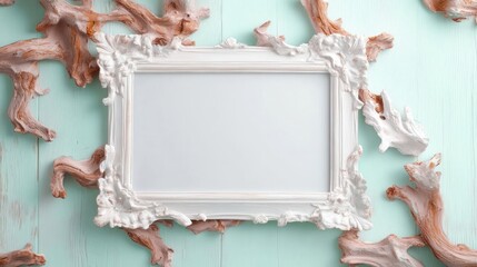 Poster - White ornate picture frame with blank space on a turquoise wood surface with coral-like decorations overhead view