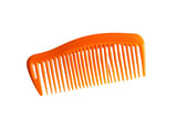 Bright orange plastic comb resting on a smooth white surface during early morning light isolated on transparent background
