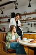 © Bliss - Young couple enjoys a cozy morning together with coffee and pastries in their modern home