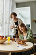 © Bliss - Young couple enjoying a cozy morning at home with breakfast and a warm beverage together